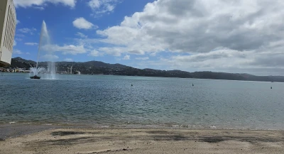 At Oriental Bay Beach, a fountain on the left side gracefully sprays water, adding to the picturesque scene.