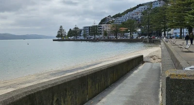 Oriental Bay concrete ramp that leads to the sandy waterfront.