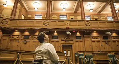 Young tourist admires the inside of New Zealand's parliament. 