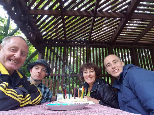 The Malone family celebrating a birthday with a cake