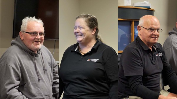 A column for each person Scott, Kate and Grant. Scott is in his late thirties, has white hair, is wearing glasses and a grey hoody. Kate is in her late forties has shoulder length brown hair and is wearing a Volunteer Central black uniform. Grant is in retirement age, has white hair, glasses and is wearing a Volunteer Central uniform. 