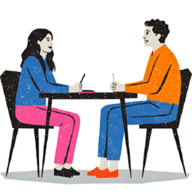 image of two people chatting at a table