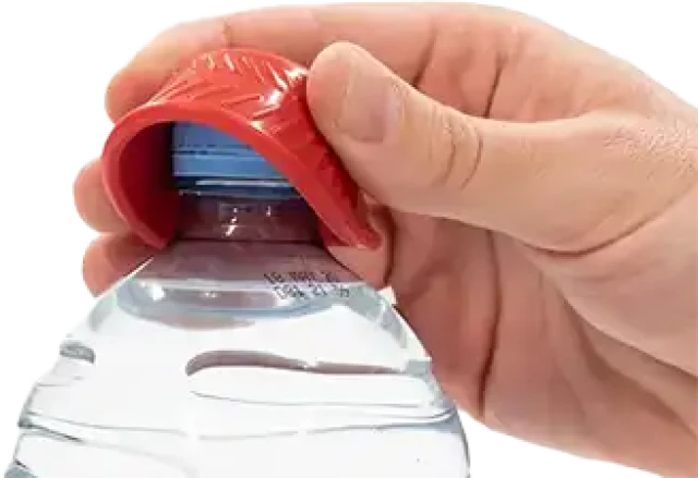 A red, circular rubber lid opener with a textured, non-slip surface opens a water bottle.