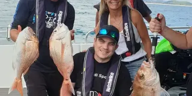 A fishing crew sport their freshly caught fish.
