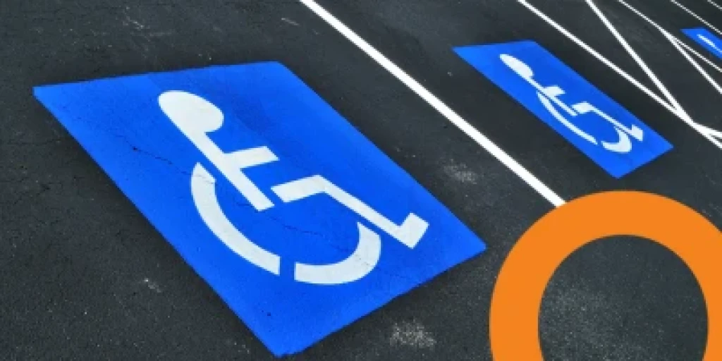A disability parking space with a blue and white wheelchair symbol.