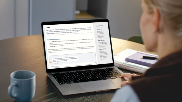 An over the shoulder shot of a woman looking at a laptop with the Firstport AI assistant on the screen