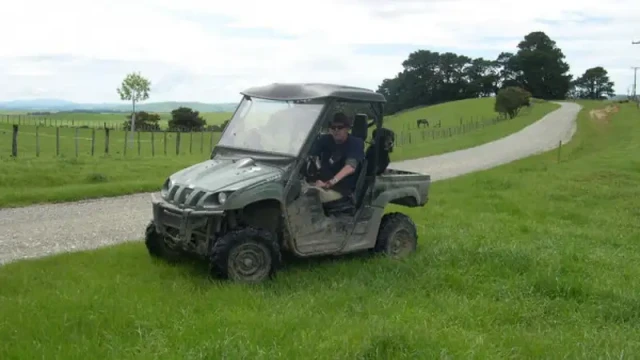 Wayne Forest rides in a side-by-side riding along a beautiful green paddock.