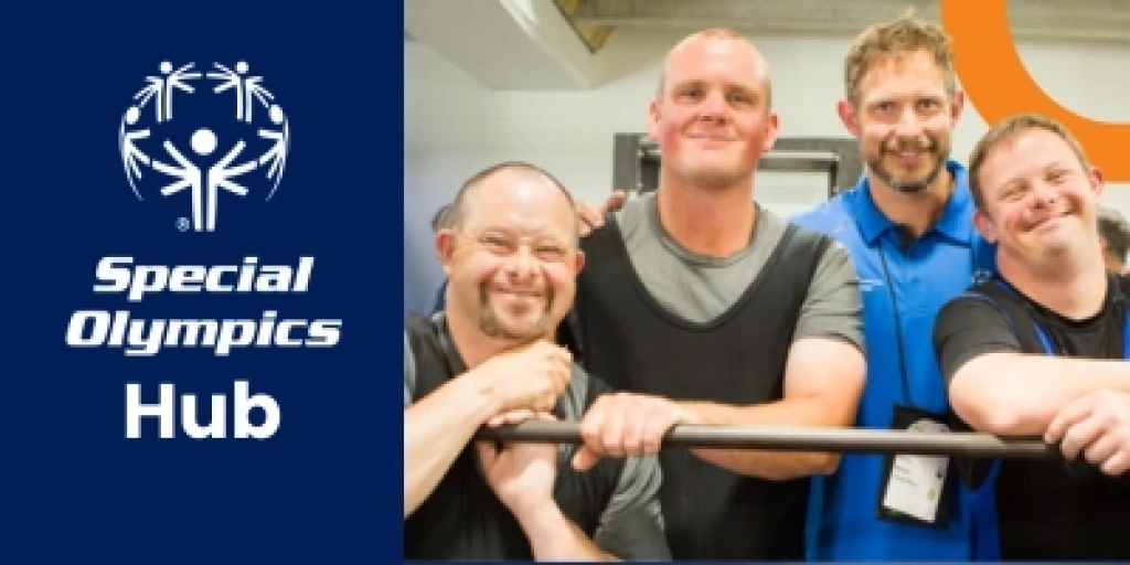three weightlifteres wearning black singlets lean on a barbell, with their coach standing behind them.