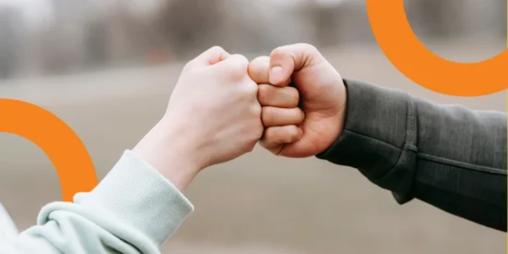Two hands fist bumping