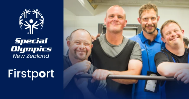 Four weightlifters leaning on a barbell