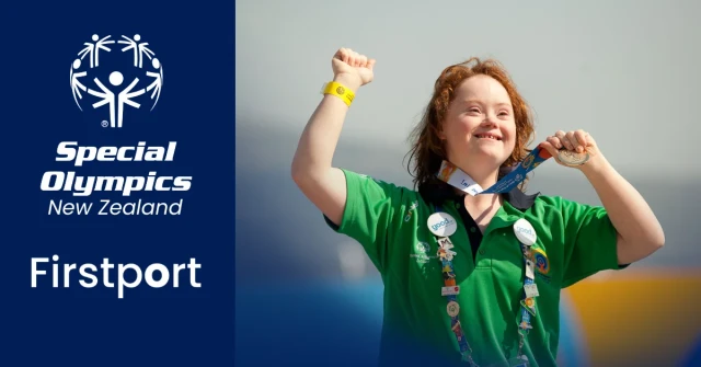 A female Special Olympics athlete wearing a green polos shirt and a medal she won