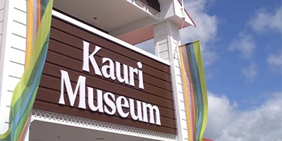 The front entrance sign for Kauri Museum - a brown sign with 'Kauri Museum' in white