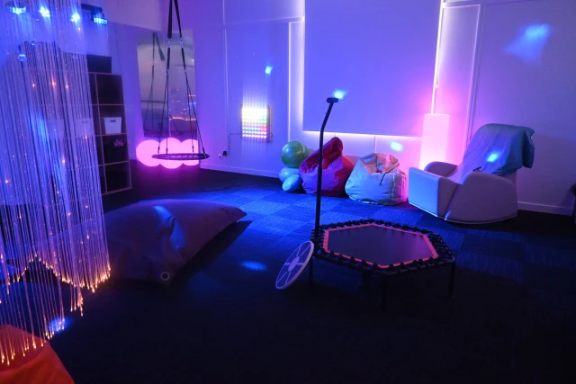 Sensory space room with lights, beanbags, a swing, and rocking chair