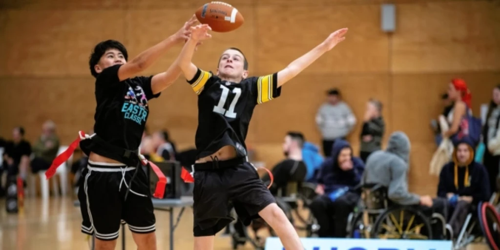 Two boys playing flag football at the 2025 Festival of Disability Sports