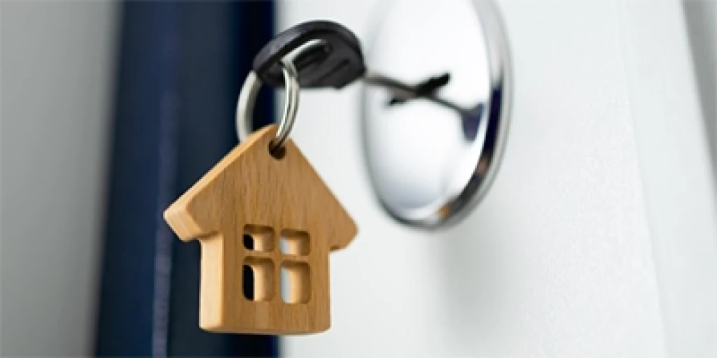 A key with a house shaped keyring