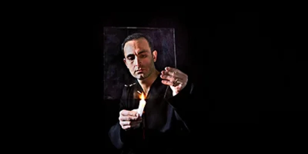 Khalid Abdalla wearing a black shirt