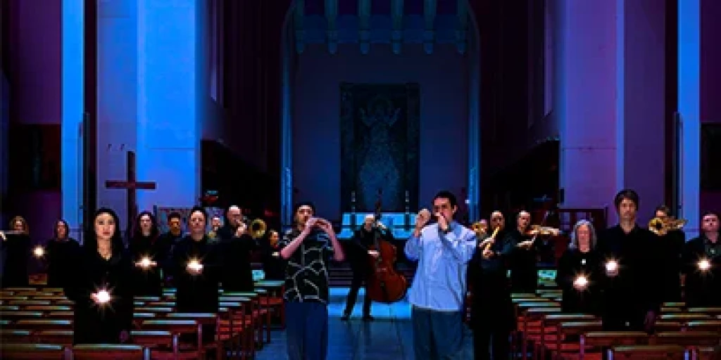 A band with orchestral instruments performing in a dimly lit cathedral