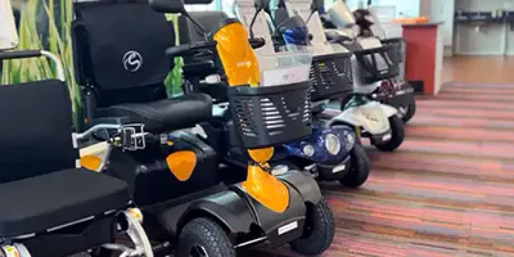 Four mobility scooters grouped in a line.