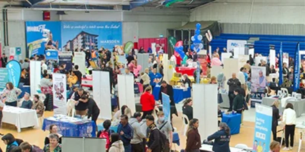 A crowd of people and stalls at the Transition expo