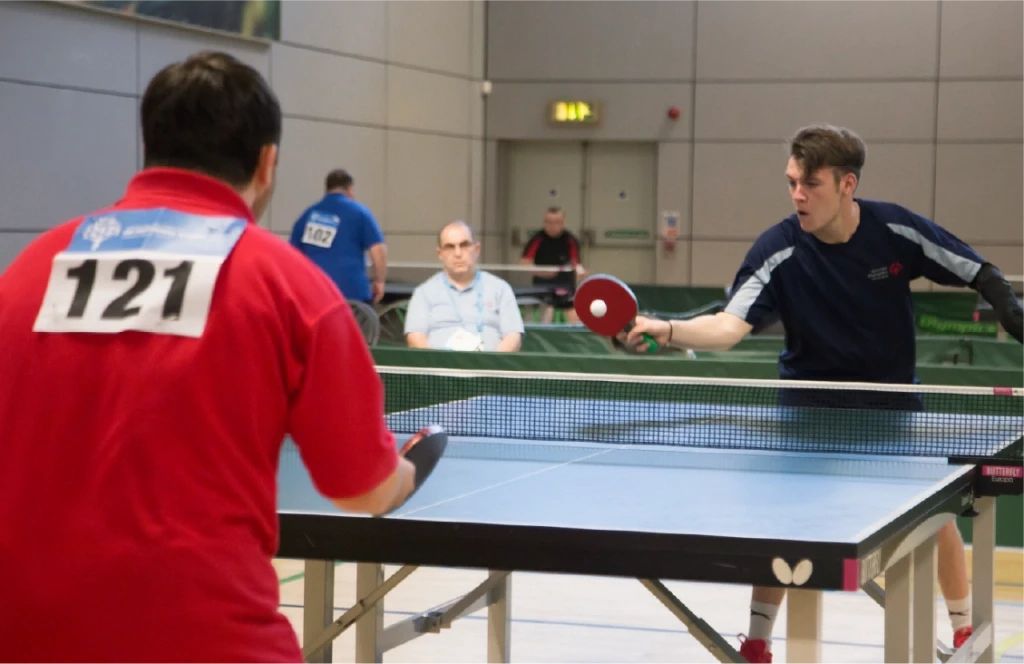 Two men playing table tennis